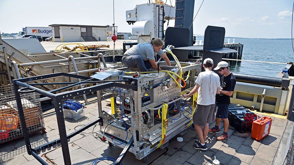 WHOI mechanical engineer Kaitlyn Tradd sits on the new towed vehicle Deep-See