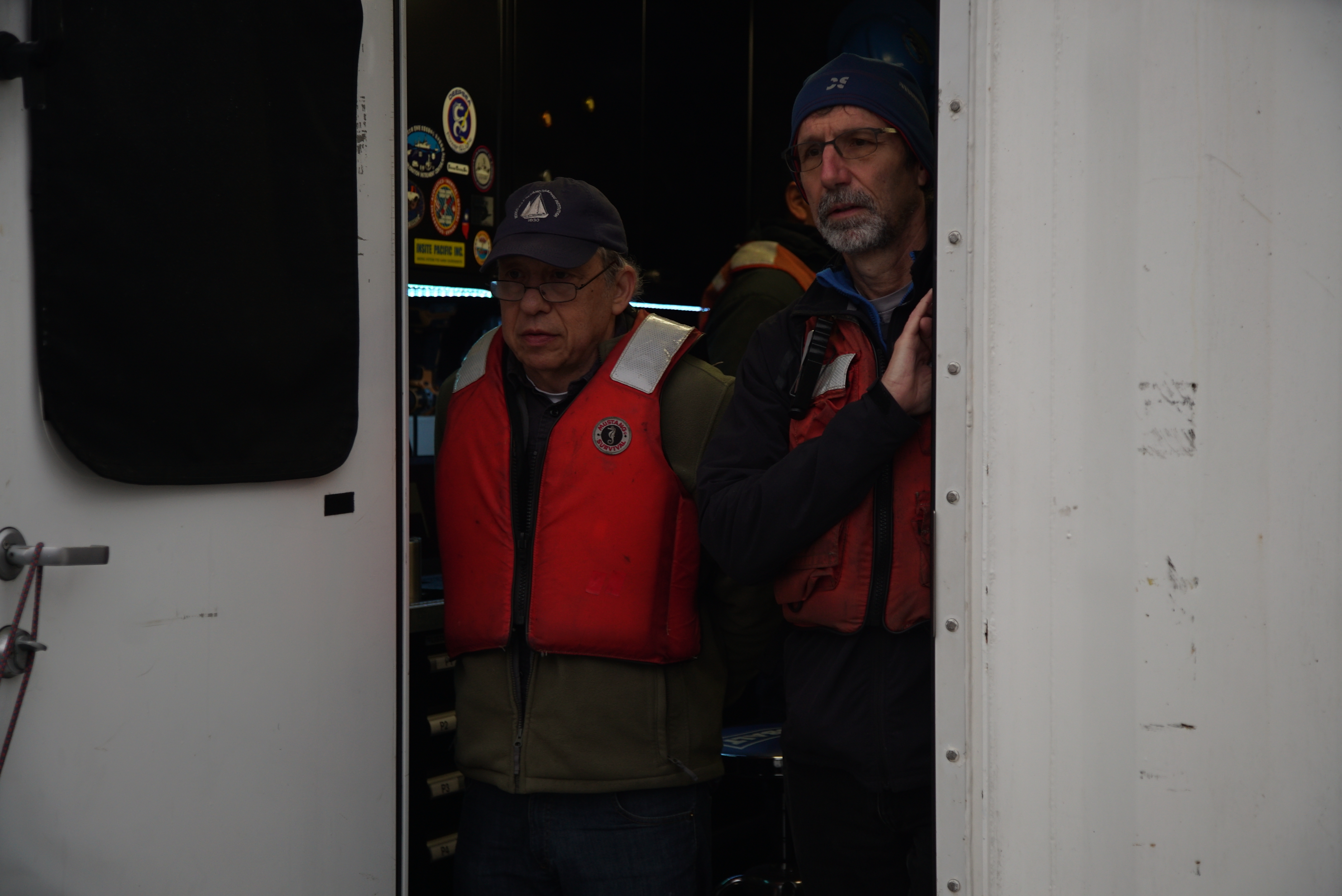 Dana Yoerger and Jon Howland look out a door while mesobot is deployed