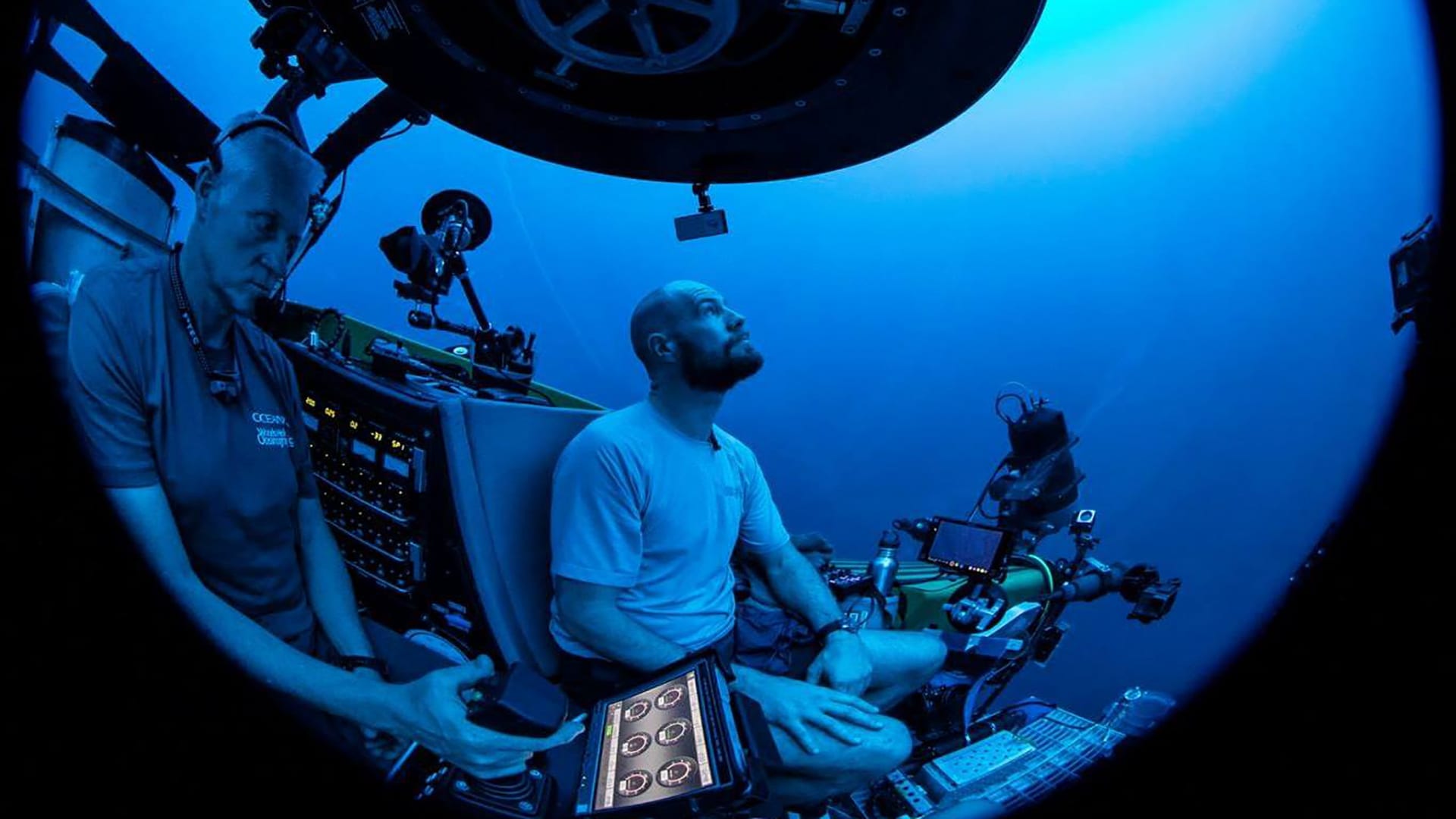 Paul Caiger descends to the ocean twilight zone on the OceanX submersible, Nadir, with pilot Alan Scott at the controls. (Photo by © OceanX Media)