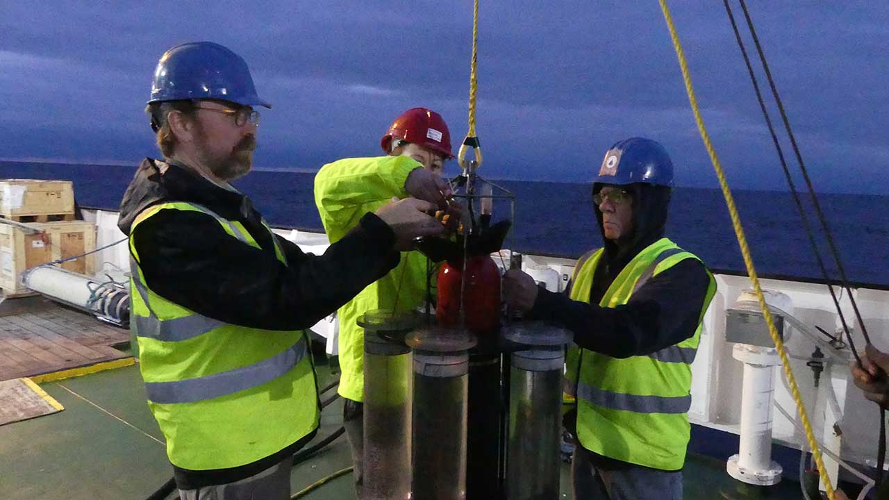 WHOI marine chemist Ken Buesseler (left) and research specialist Steven Pike prepare to deploy a sediment trap to gain insight into the role of the upper ocean in Earth's carbon cycle and climate system. (Photo by Jennifer Kenyon, Woods Hole Oceanographic Institution)