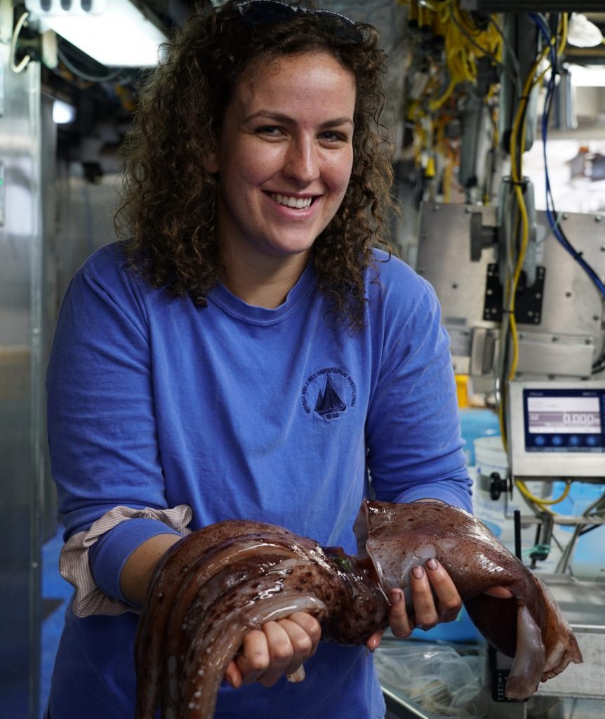 Kayla Gardner, an MIT-WHOI joint PhD student, holds one of the largest strawberry squids ever captured from the ocean twilight zone.