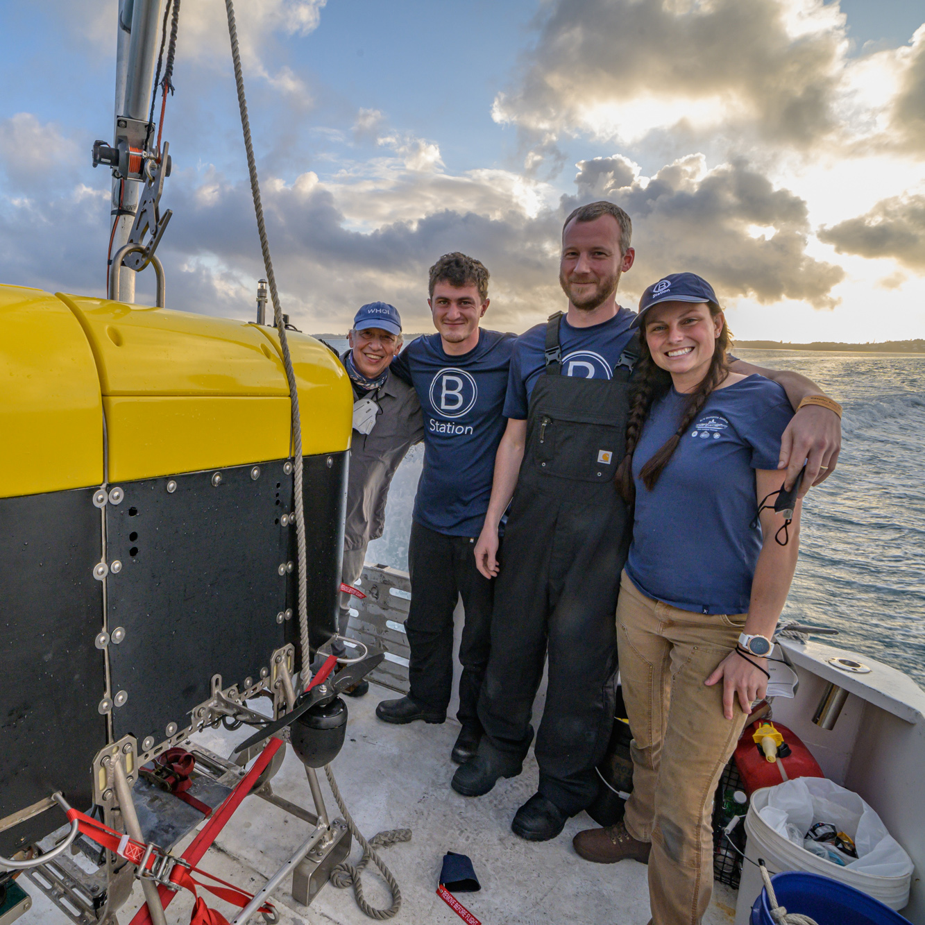 OTZ scientists and engineers Dana Yoerger, William Pardis, Eric Hayden, and Molly Curran (left to right) pose next to Mesobot, an autonomous underwater vehicle built to explore life in the twilight zone, as it undergoes testing in Bermuda.