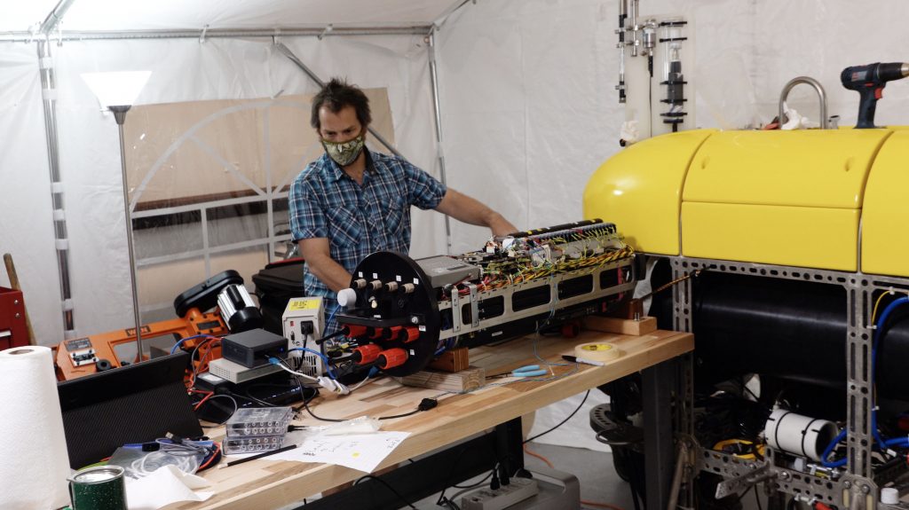 Engineer Jordan Stanway troubleshoots a problem in one of Mesobot's motors.