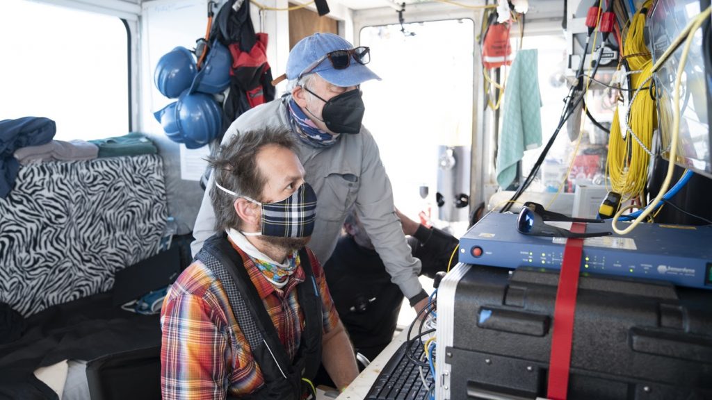 WHOI Senior Scientist Dana Yoerger (right) and Engineer Jordan Stanway (left) review <em>Mesobot</em>'s dive plan before its first deep-water deployment. Instructions to the vehicle can be pre-programmed before sending it on its way.  Credit: Jennifer Berglund