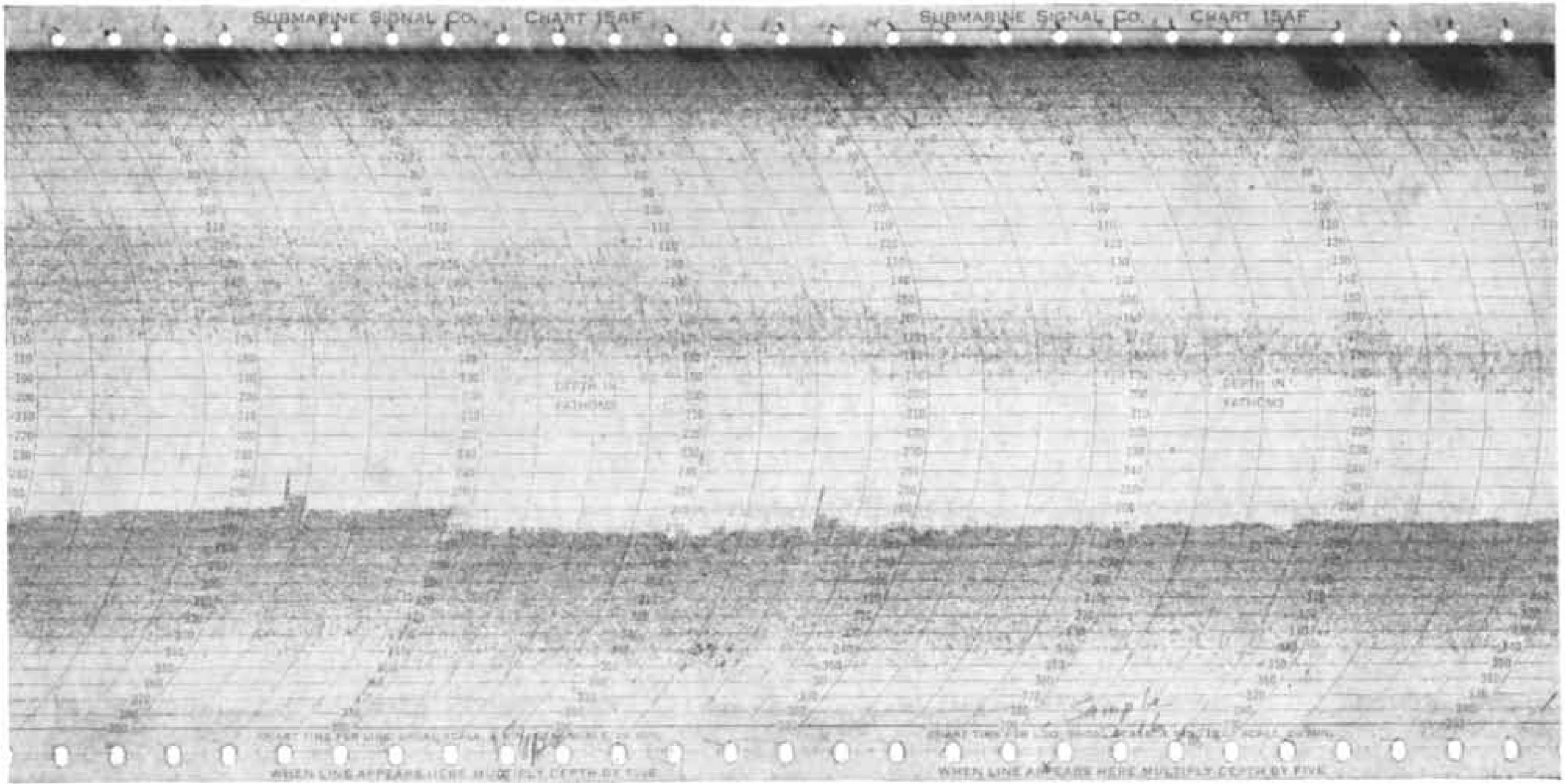 This echo-sounder recording from the 1950s shows the Deep Scattering layer as a faint trace running across the middle of the image. The stronger trace below it is the seafloor. 