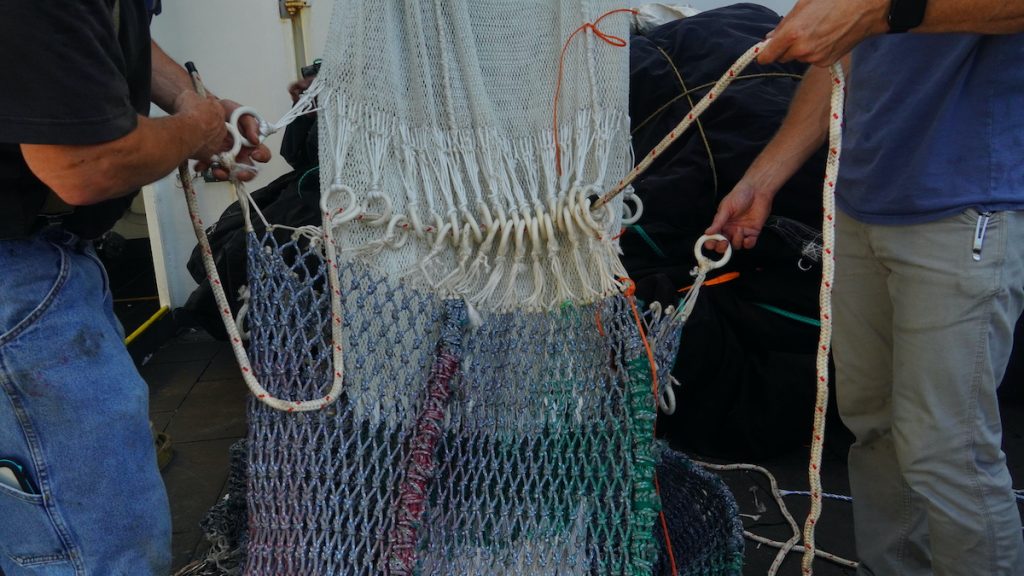 Science personnel untangle the ropes that make up the MOCNESS tow net aboard the R/V Henry B. Bigelow. (Photo by Andrea Vale © Woods Hole Oceanographic Institution)
