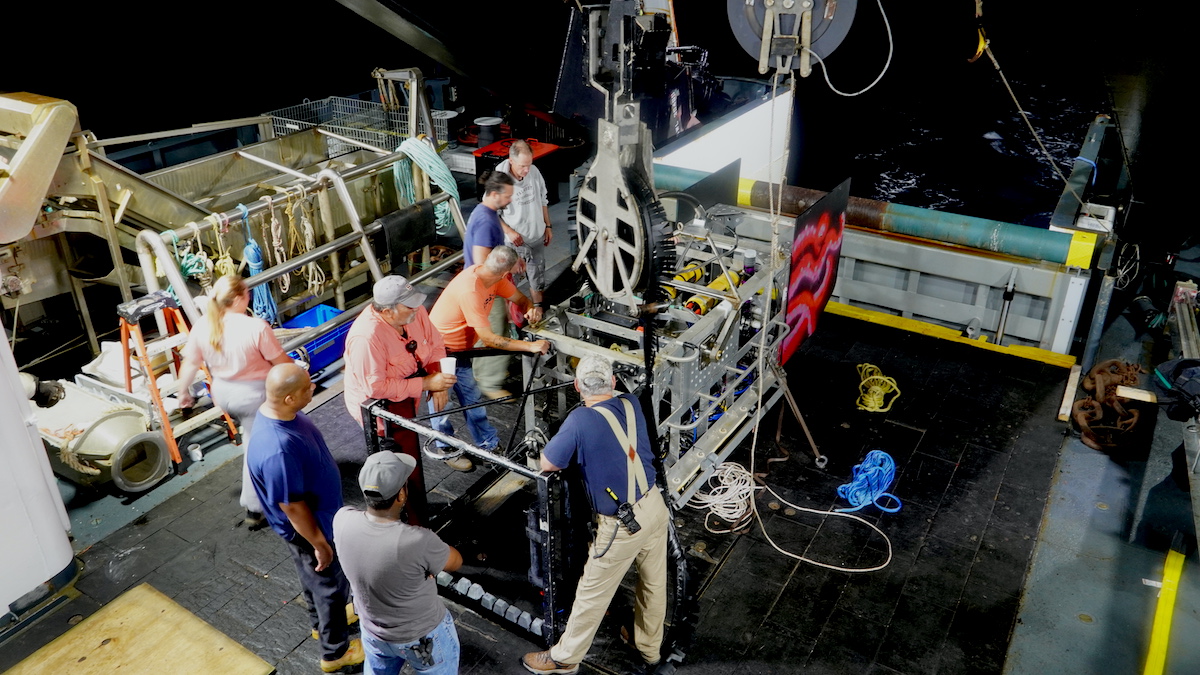 Engineering personnel make final checks and adjustments to the Deep-See before its first deployment. Weighing 2,500 pounds, the Deep-See requires several team members - and a strong winch - to deploy and recover. (Photo by Andrea Vale © Woods Hole Oceanographic Institution)