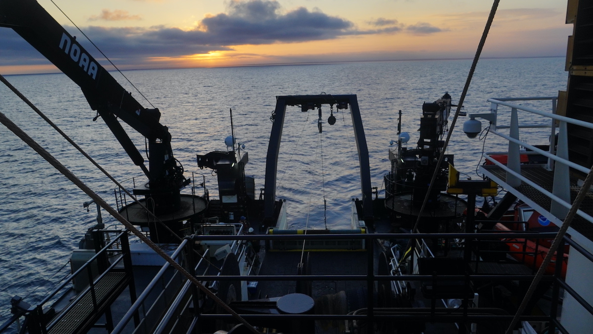 Sunset over the stern after a day of testing and attempting to repair the broken winch. (Photo by Andrea Vale © Woods Hole Oceanographic Institution)