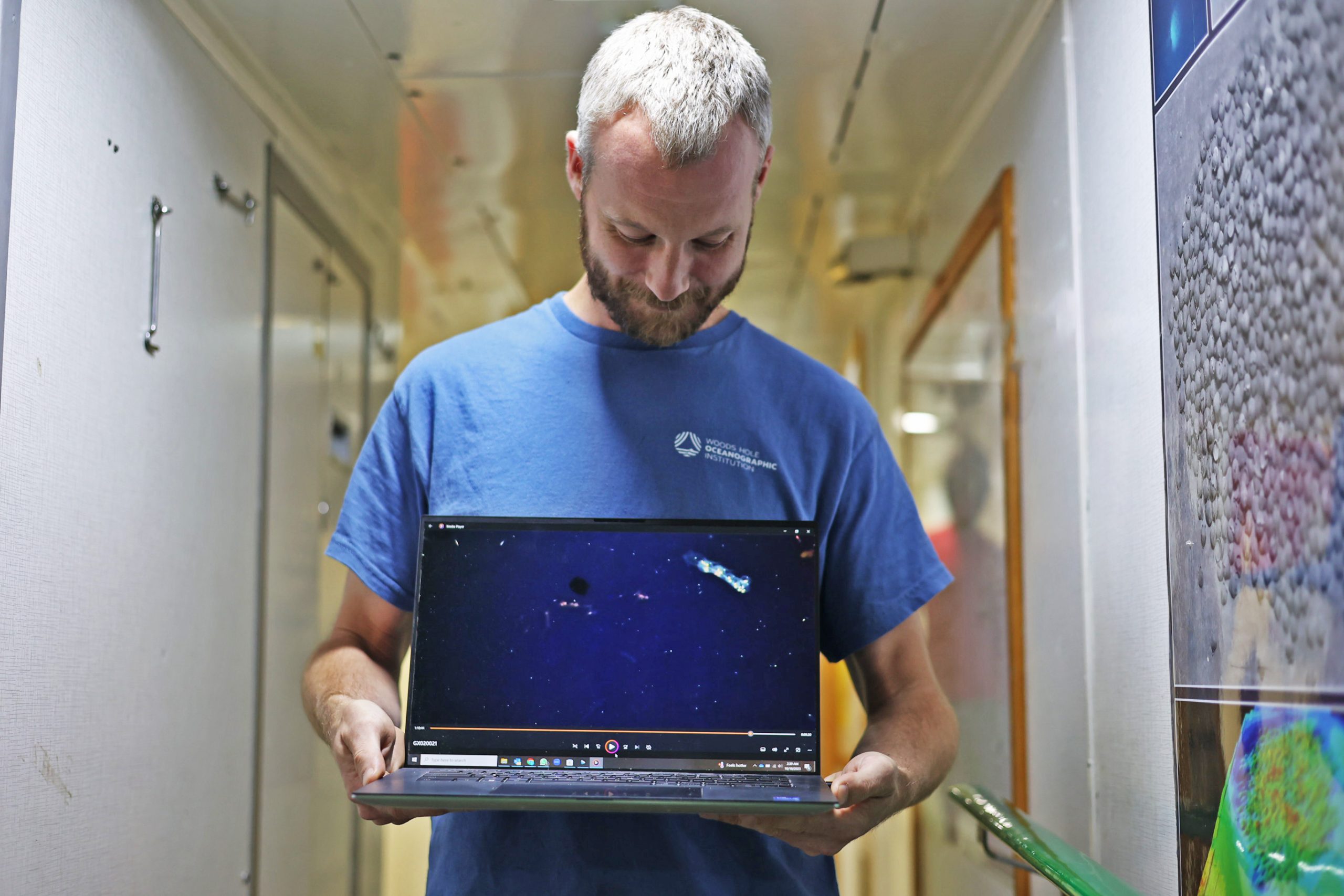 WHOI Mechanical engineer Eric Hayden shows the author a video of animals in the ocean twilight zone. The video had been recorded by <i>Mesobot</i> only moments before.