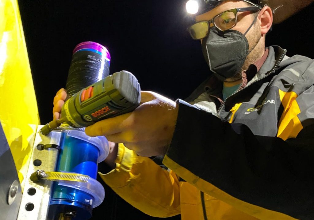 Research Technician Fredrick Marin attaches a highly-sensitive radiometer to <em>Mesobot</em>. Credit: Jennifer Berglund
