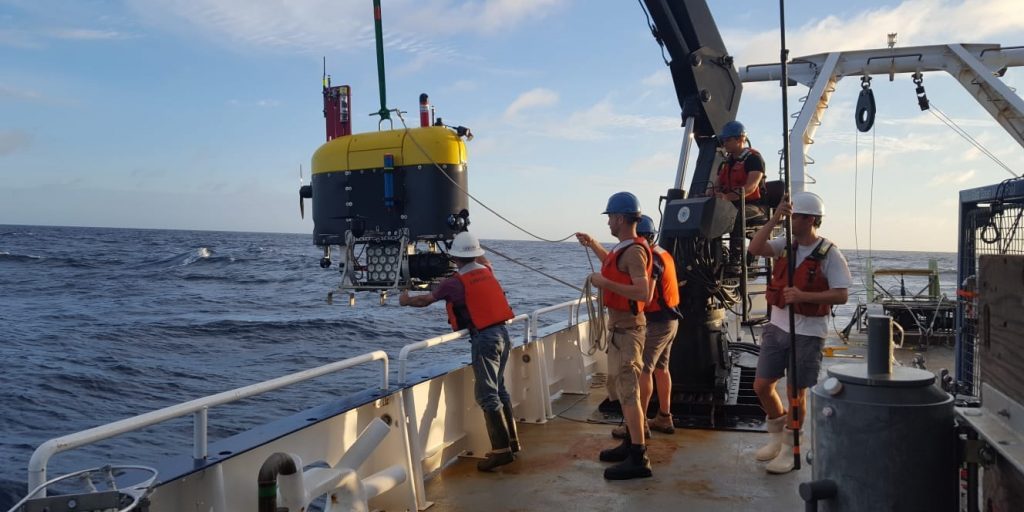 Mesobot is lowered over the side of the R/V Endeavor. This powerful imaging robot captures video of gelatinous animals as well as eDNA samples from the water column. (Photo © Woods Hole Oceanographic Institution)